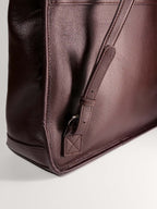 Brown Amari top grain leather backpack close up adjustable buckle strap