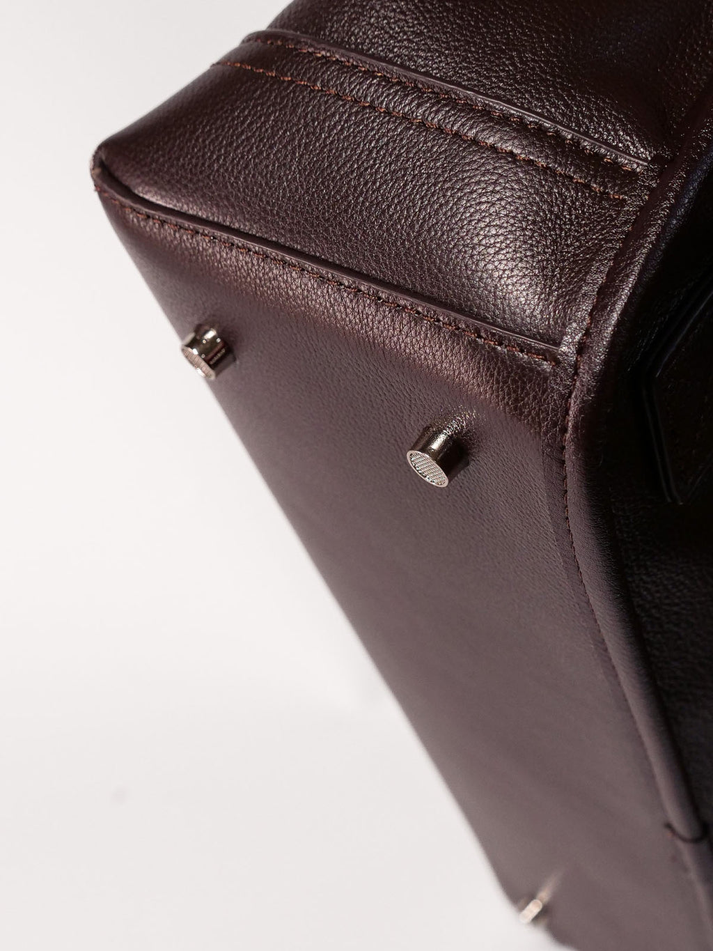 Brown Amari top grain leather backpack close up of bottom of bag