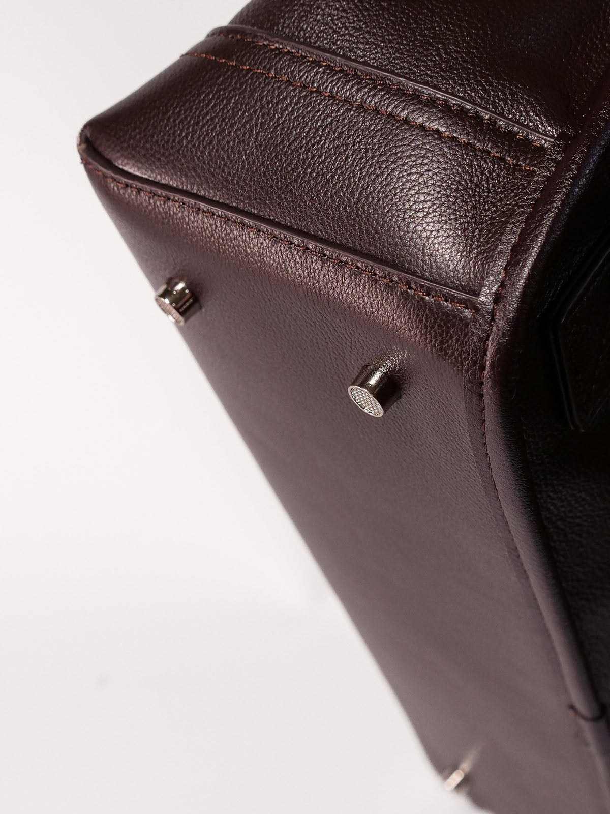 Brown Amari top grain leather backpack close up of bottom of bag