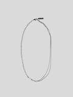 Antonii stainless steel necklace on plain background