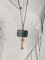 Beni black leather keychain worn as a necklace with key attached