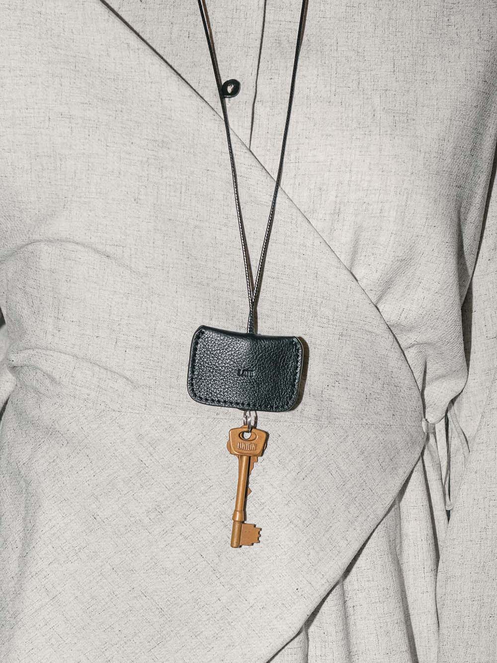 Beni black leather keychain worn as a necklace with key attached