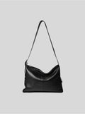 Top-grain black Medium Kite Bag on a plain grey background