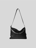 Top-grain black Medium Kite Bag on a plain grey background