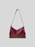 Top-grain burgundy Medium Kite Bag on a plain grey background