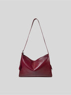 Top-grain burgundy Medium Kite Bag on a plain grey background