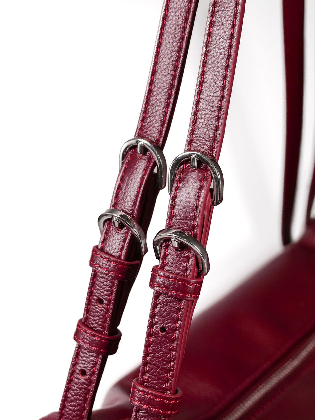 Close up of burgundy Willow Bag straps showing 4 silver buckles