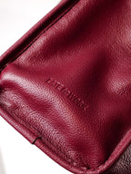 Close up of Willow Bag leather with 'Late to Work' embossed logo
