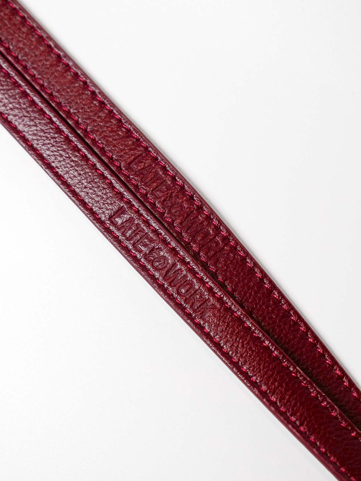 Close up of Willow Bag straps with 'Late to Work' embossed