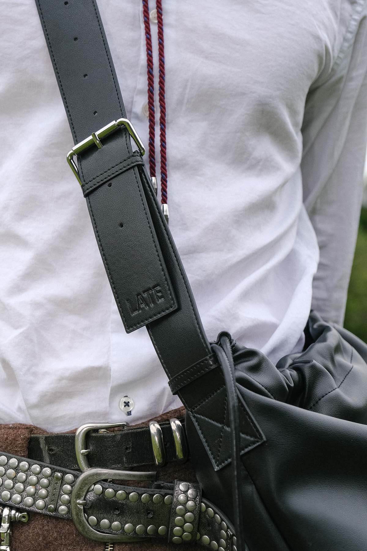 Sage crossbody bag black genuine leather strap with embossed logo close up