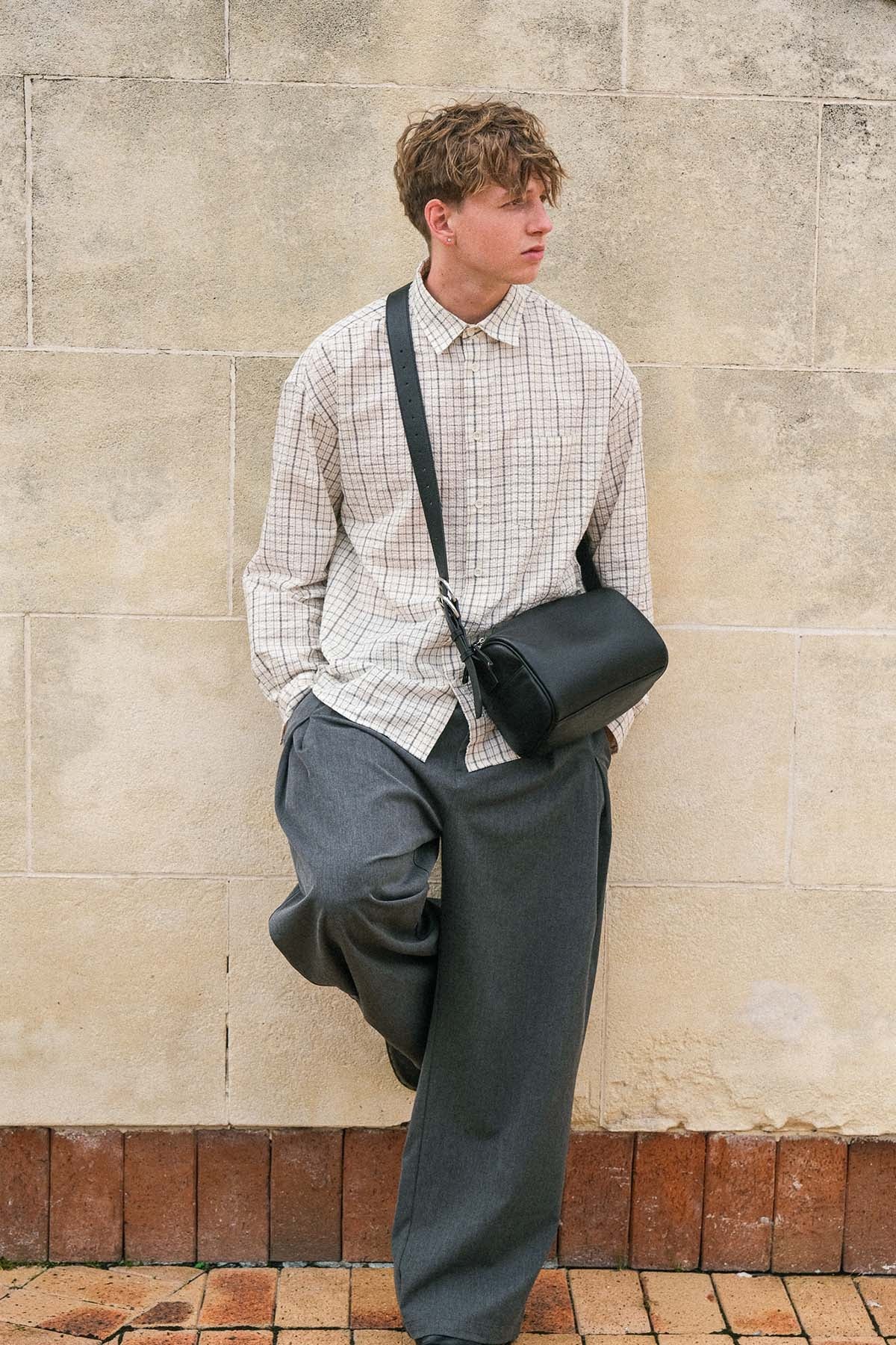 Black Fromont top grain leather crossbody bag worn crossbody