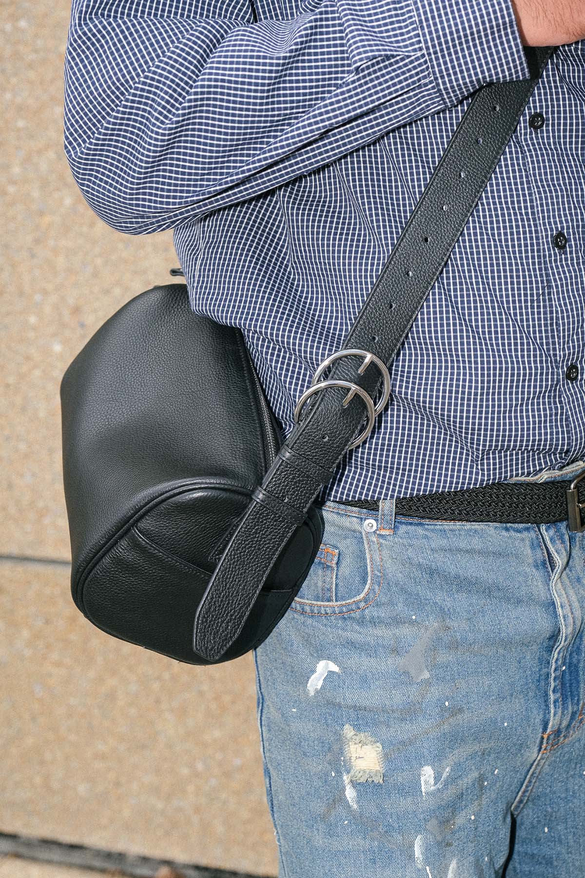 Black Fromont top grain leather crossbody bag worn crossbody close up