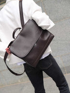 Brown Amari top grain leather backpack worn on one shoulder