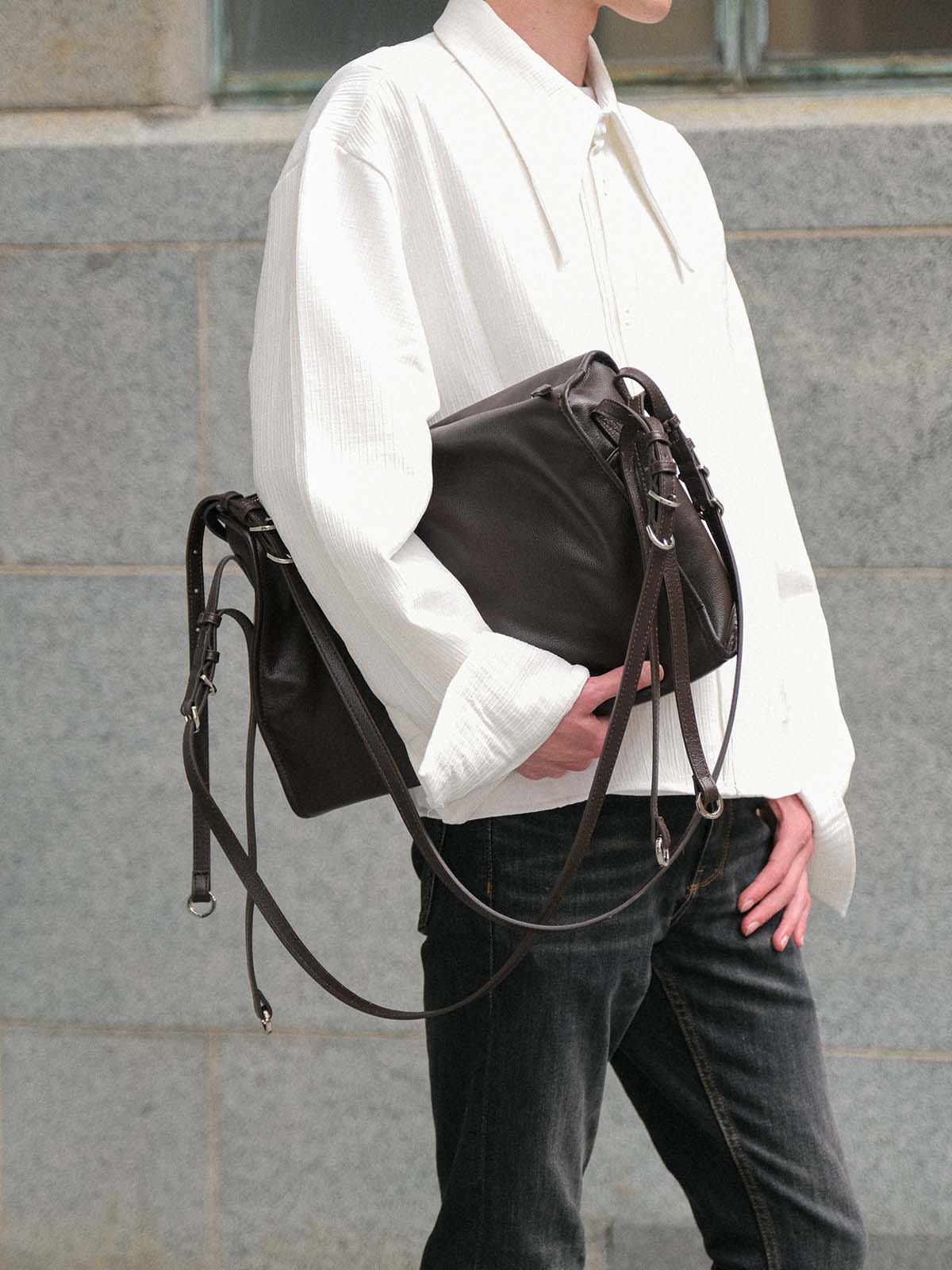 Brown Willow Bag clutched under one arm