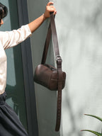 Brown Fromont Bag top-grain leather held against a wall