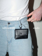 Finlay leather mini bag charm black clipped on jeans