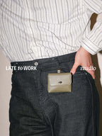 Finlay leather mini bag charm green clipped on jeans