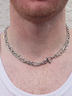 Silver chain necklace with a unique clasp worn by a person