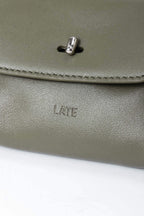 Finlay mini leather bag charm green embossed logo close up