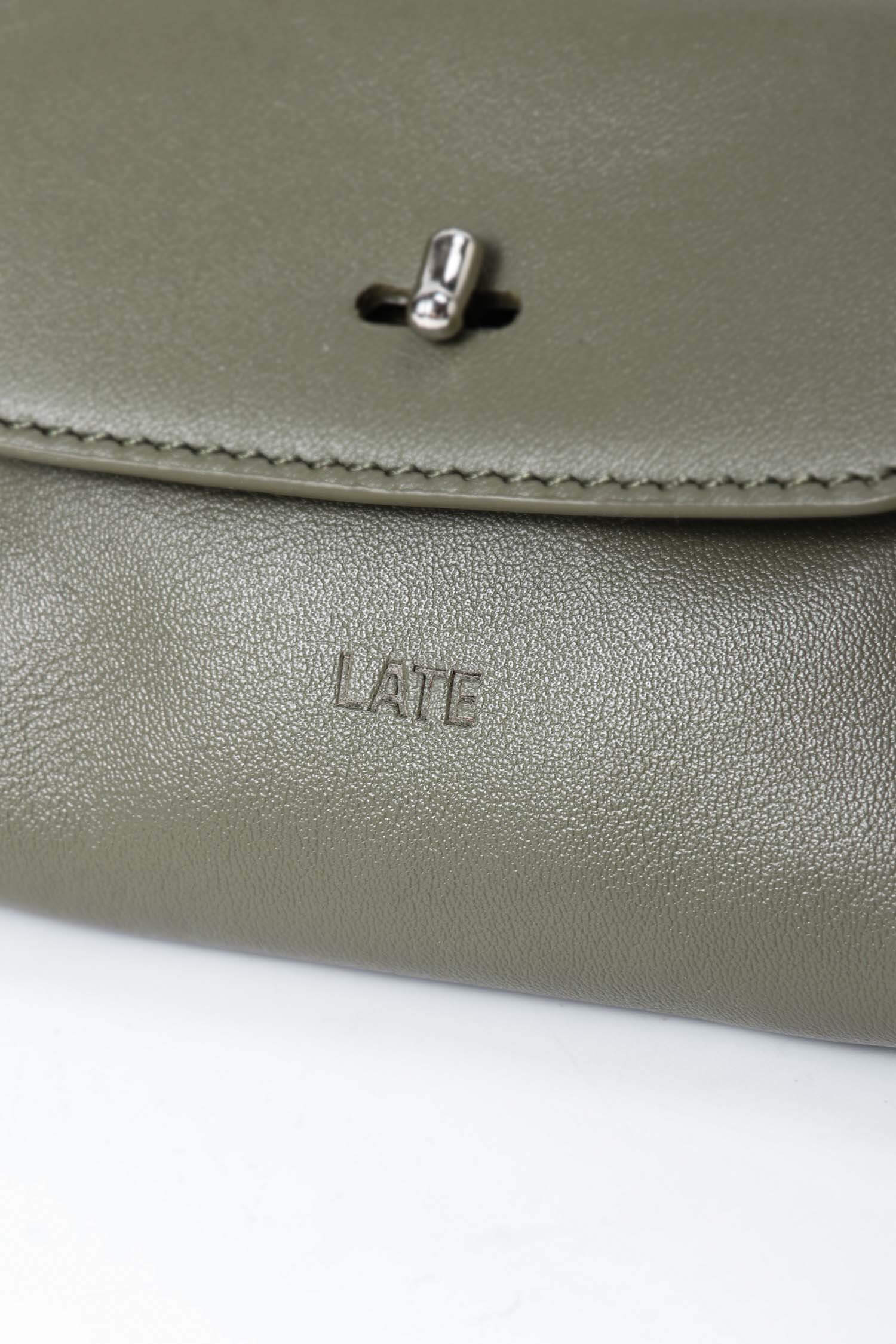Finlay mini leather bag charm green embossed logo close up