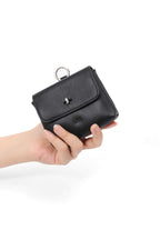 Finlay mini leather bag charm black held in hand