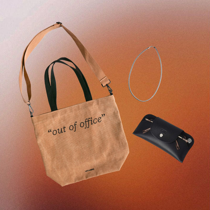 Mid-year sale gift set: tan tote bag with 'out of office' text, black sunglasses case, and stainless steel necklace