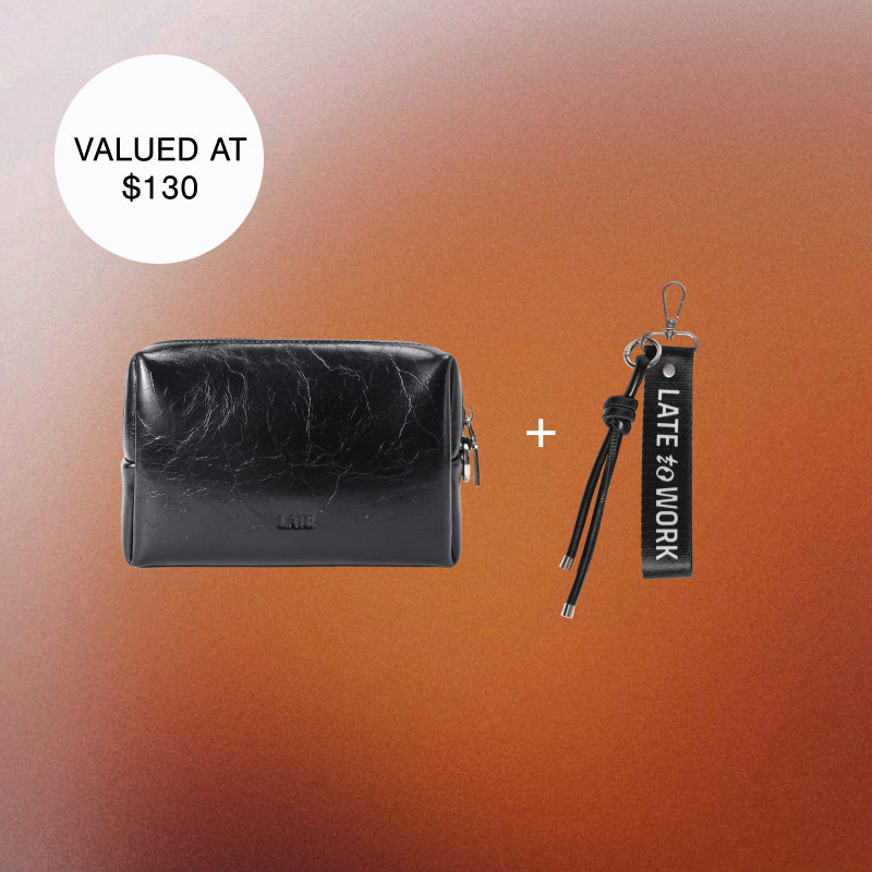 Black leather pouch and keychain set on an orange gradient background.