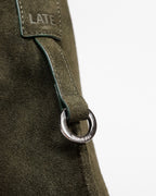 Close up of silver 'Late to Work' embossed ring on the forest suede medium Kite Bag