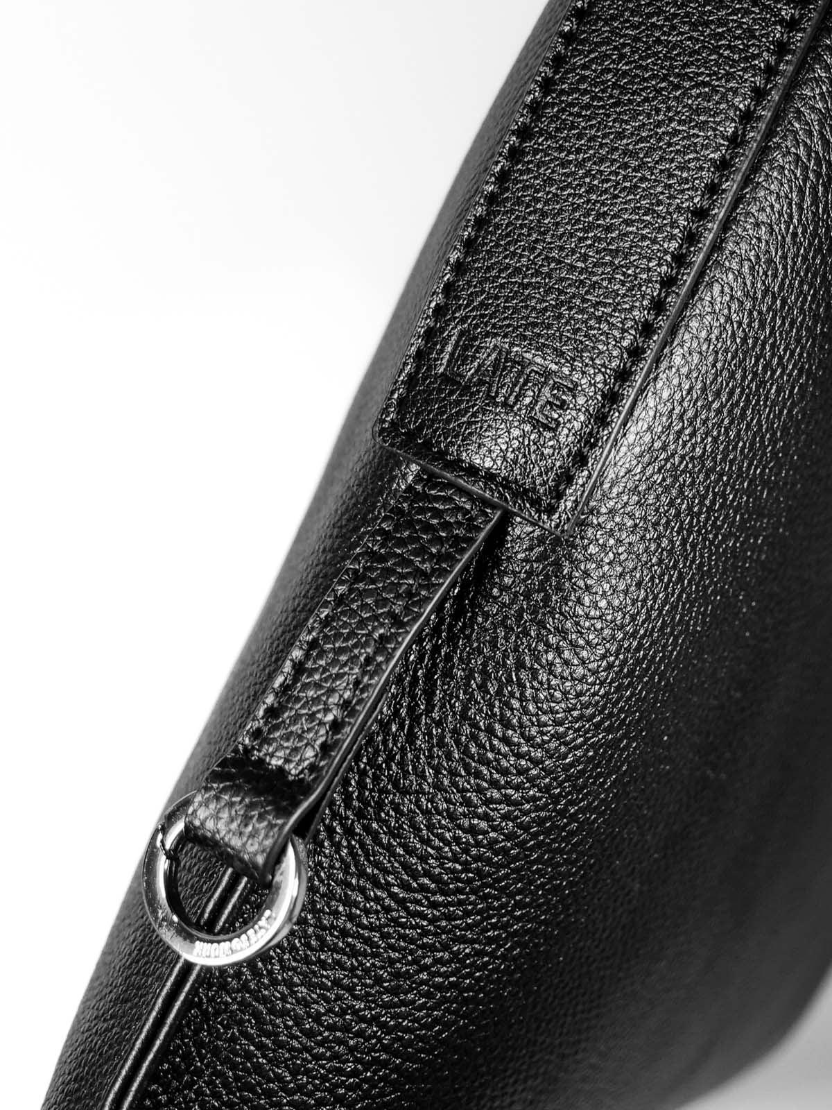 Close up of side of bag, showing silver clip ring hardware
