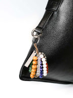Close up of bag charm hanging on silver ring