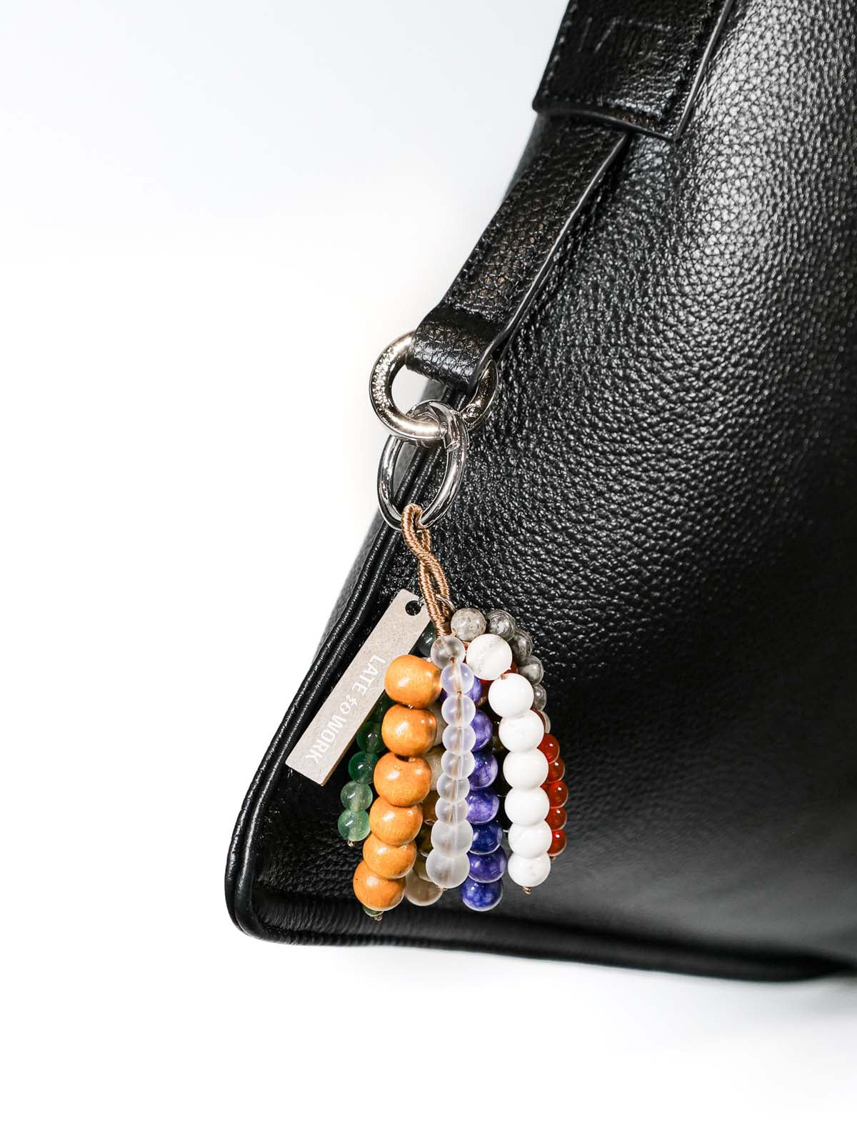 Close up of bag charm hanging on silver ring