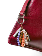 Close up of bag charm hanging on silver ring