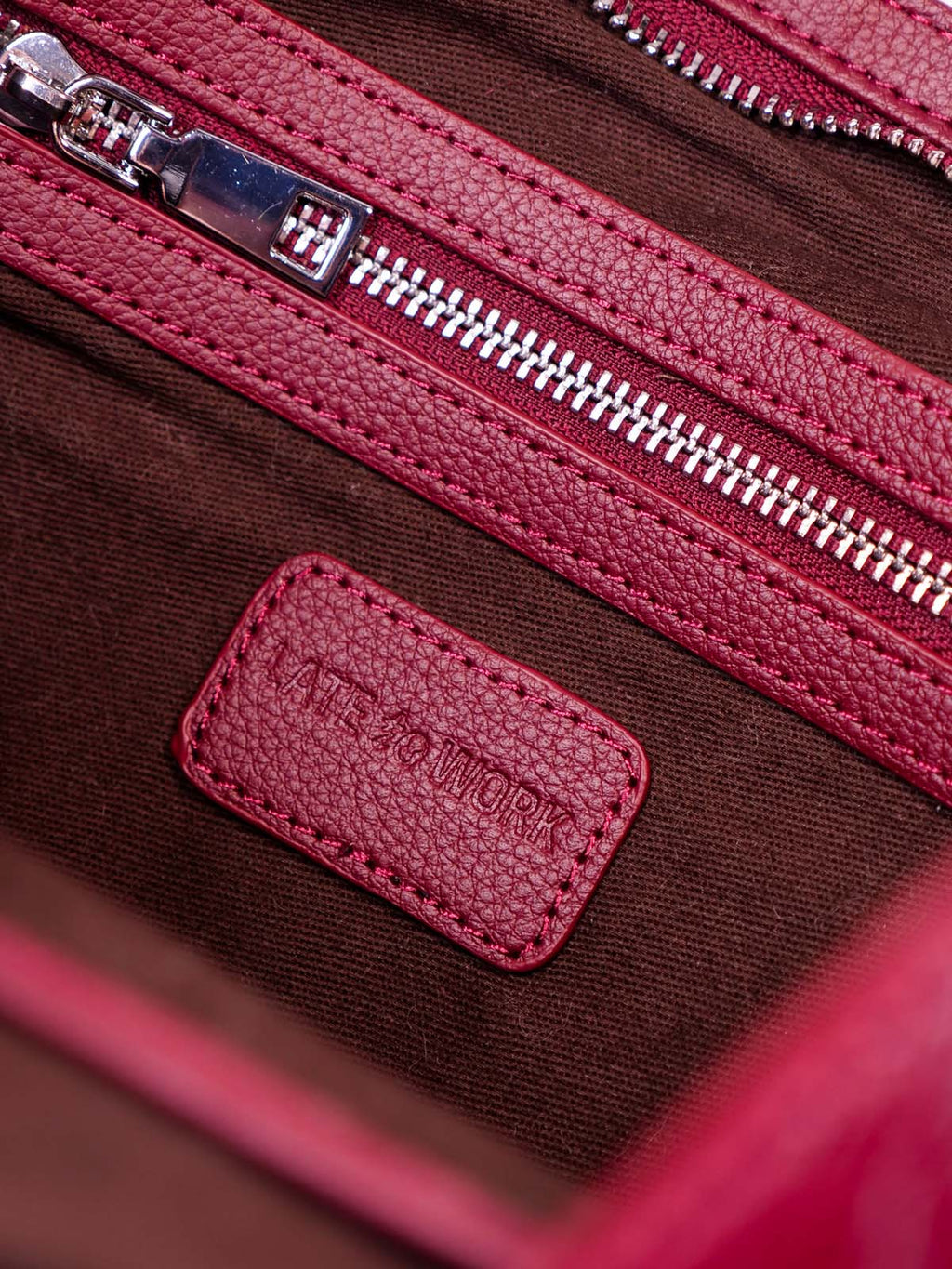 Close up interior pocket with 'Late to Work' logo tag