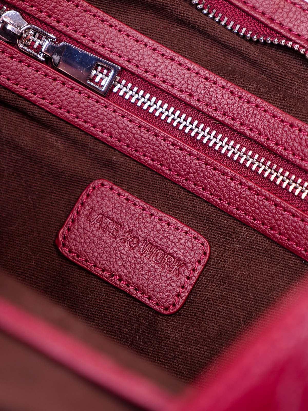 Close up interior pocket with 'Late to Work' logo tag