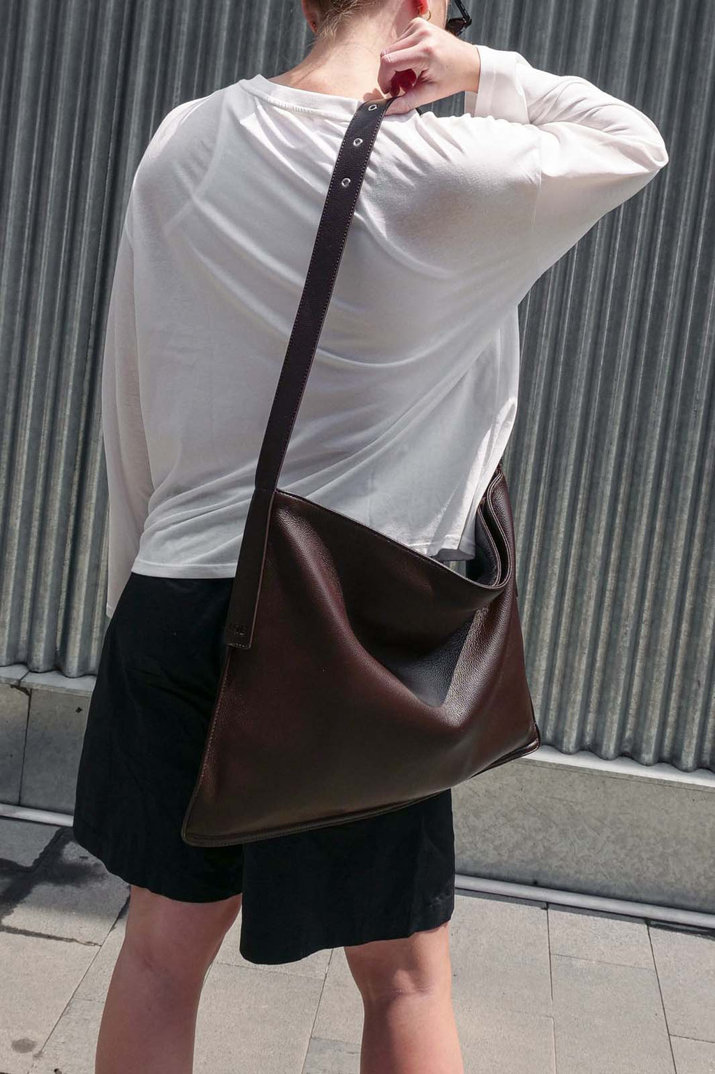 Brown Luxe Kite Bag worn on one shoulder, back view of model