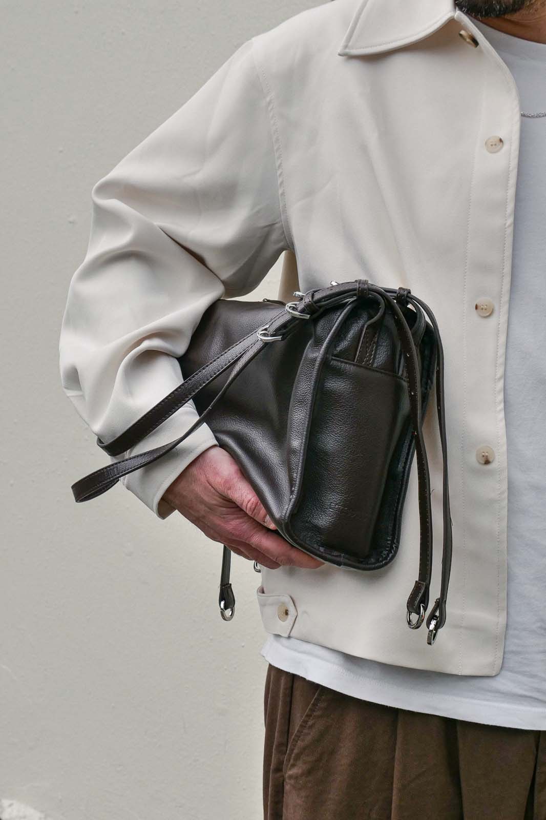 Brown small WIllow Bag held under arm