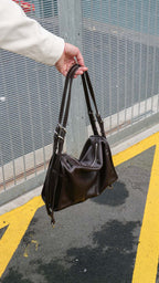 Brown Willow Bag held against concrete street