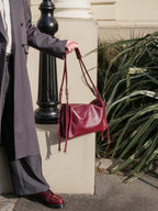 Burgundy Willow Bag resting outdoors on concrete steps