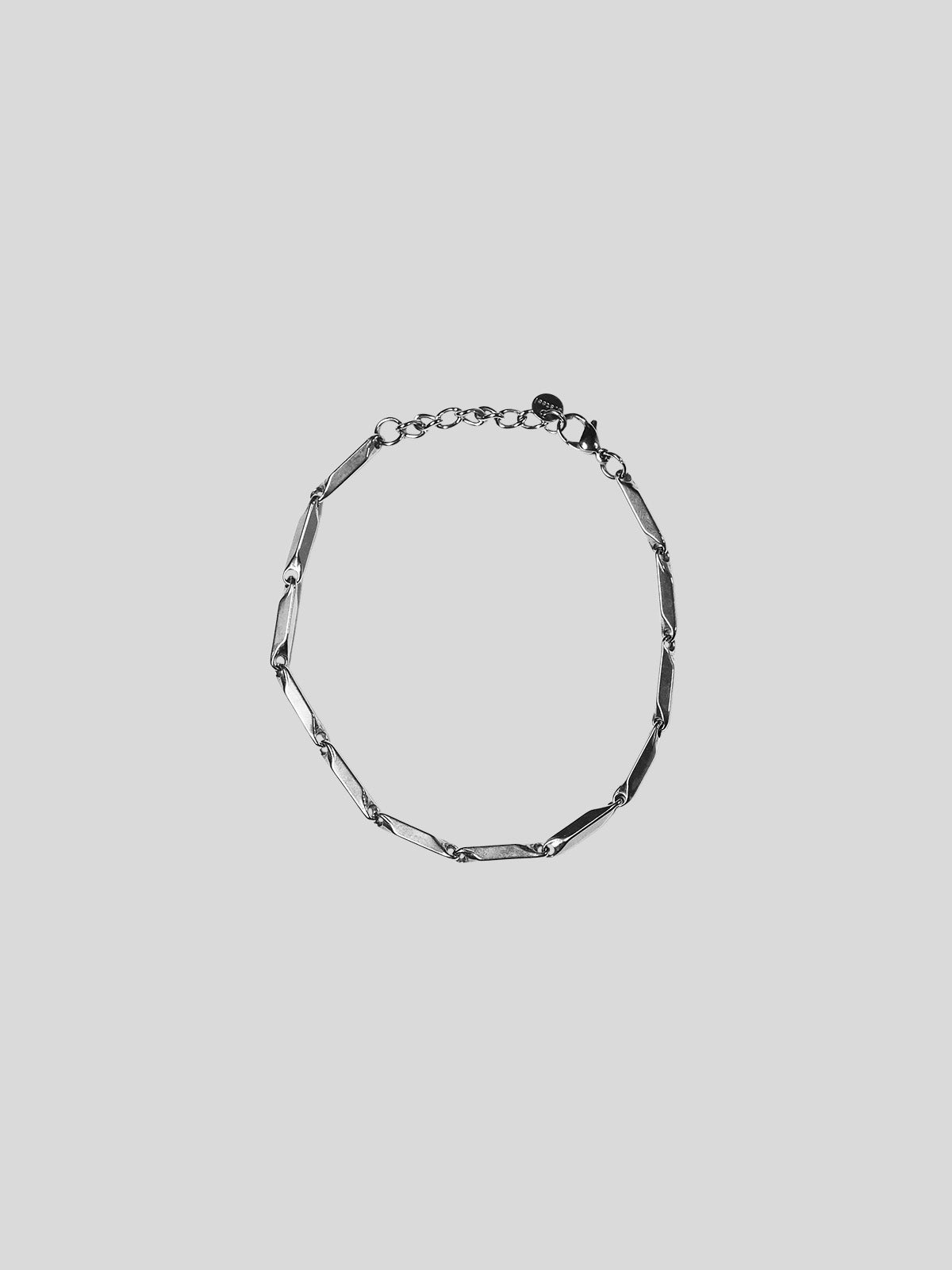 Prism stainless steel bracelet on plain background