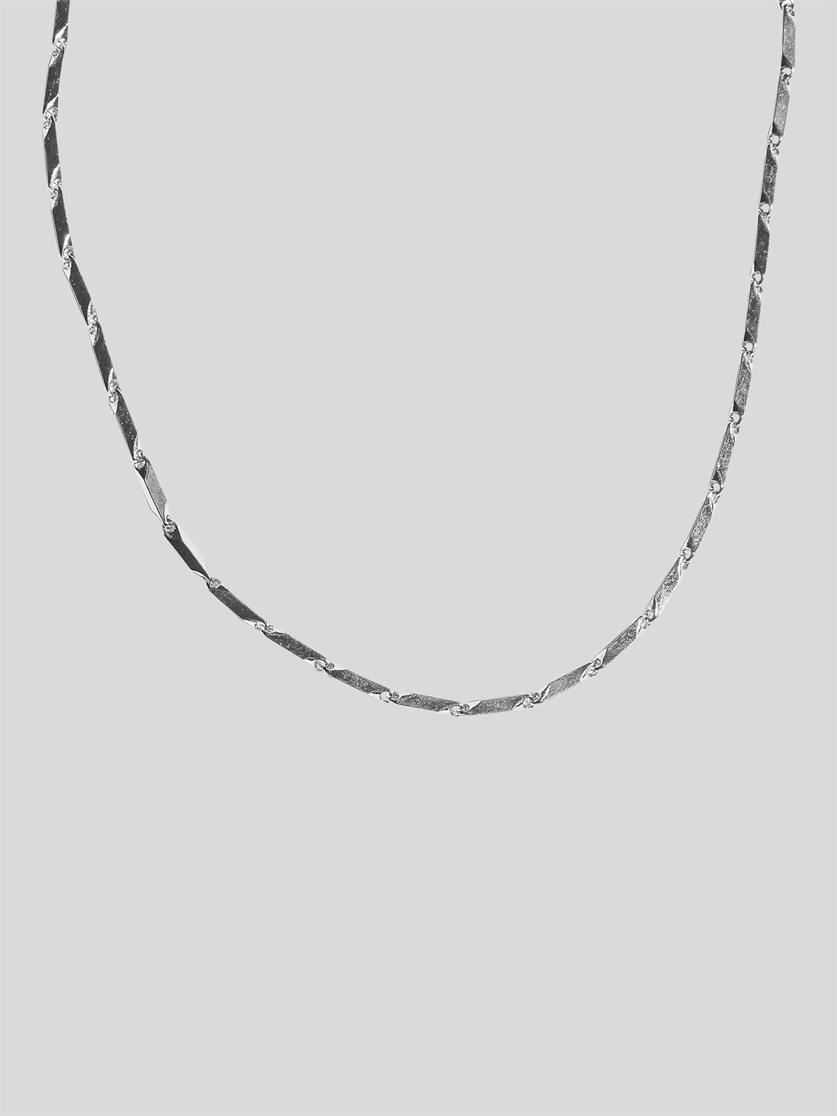Stainless steel Prism Necklace isolated on a plain background