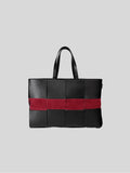 Reed woven bag front view on grey background