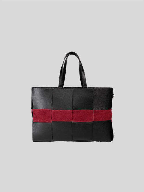 Reed woven bag front view on grey background