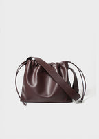 Sage crossbody bag brown genuine leather front view with strap down