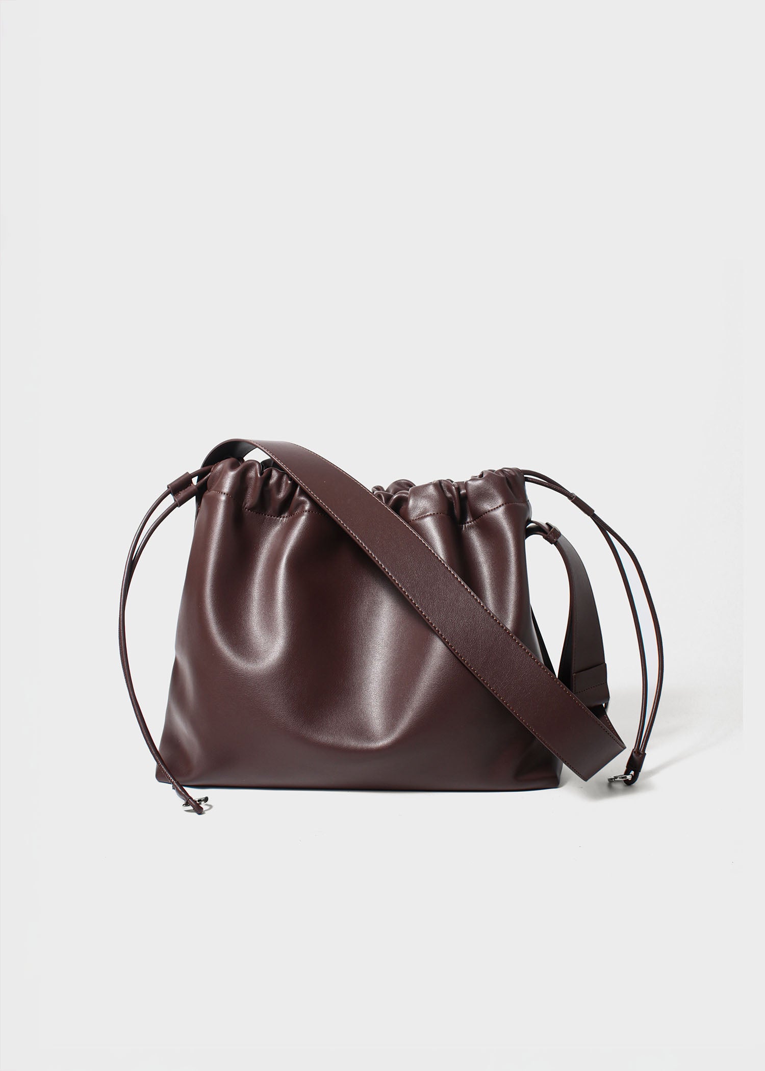 Sage crossbody bag brown genuine leather front view with strap down