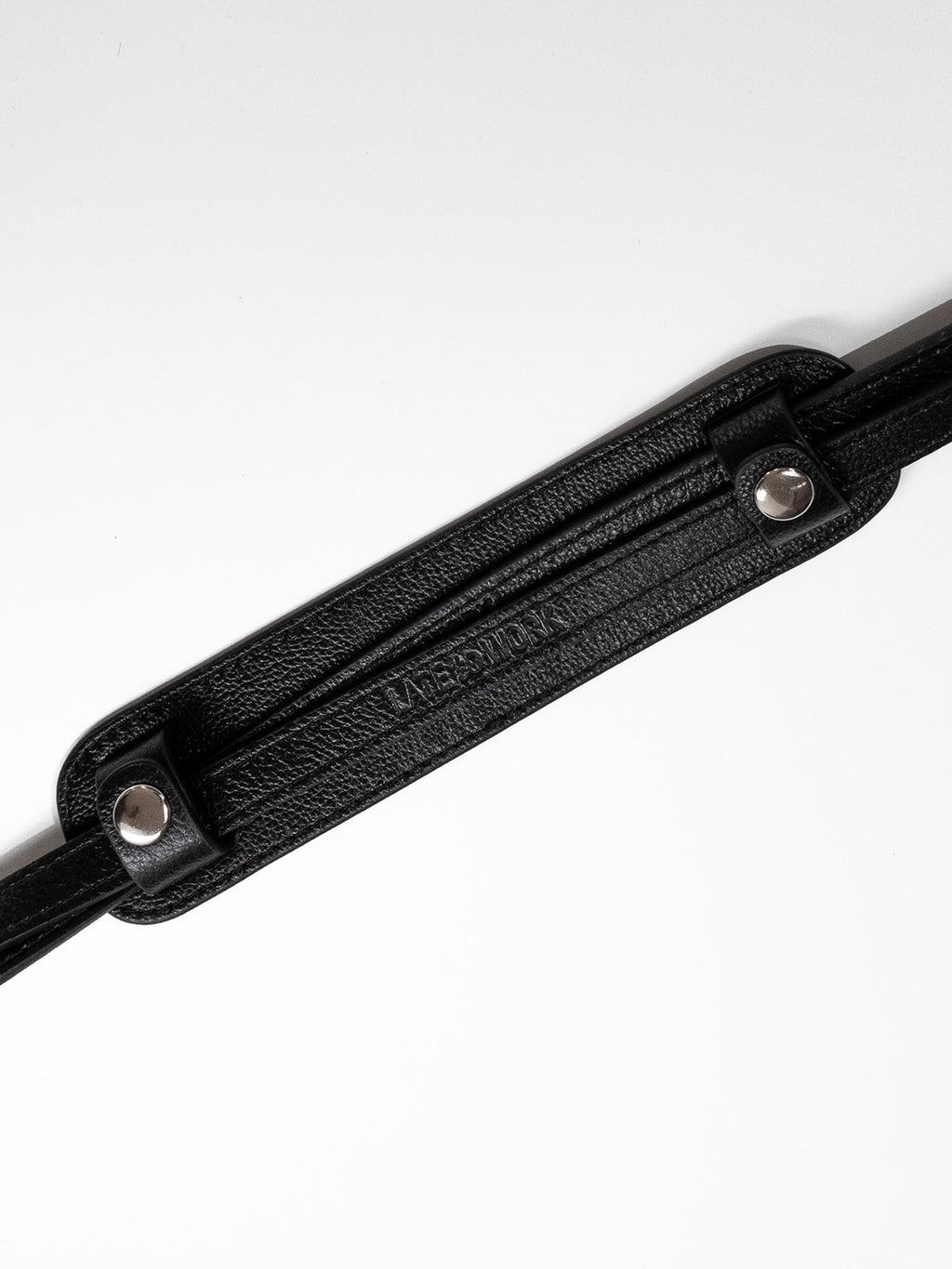 Black shoulder pad with 2 straps buttoned in