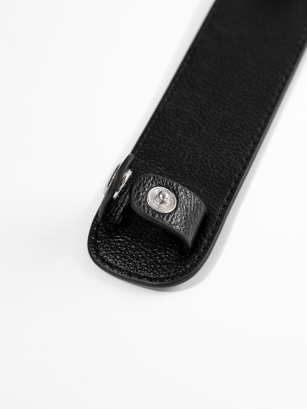 Black shoulder pad close up of button closure