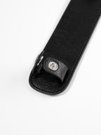 Black shoulder pad close up of button closure