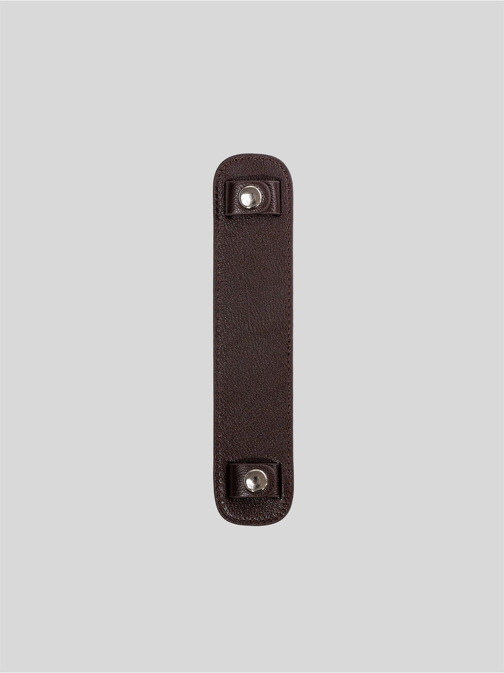 Brown top-grain leather bag strap shoulder pad isolated on grey background