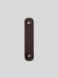 Brown top-grain leather bag strap shoulder pad isolated on grey background