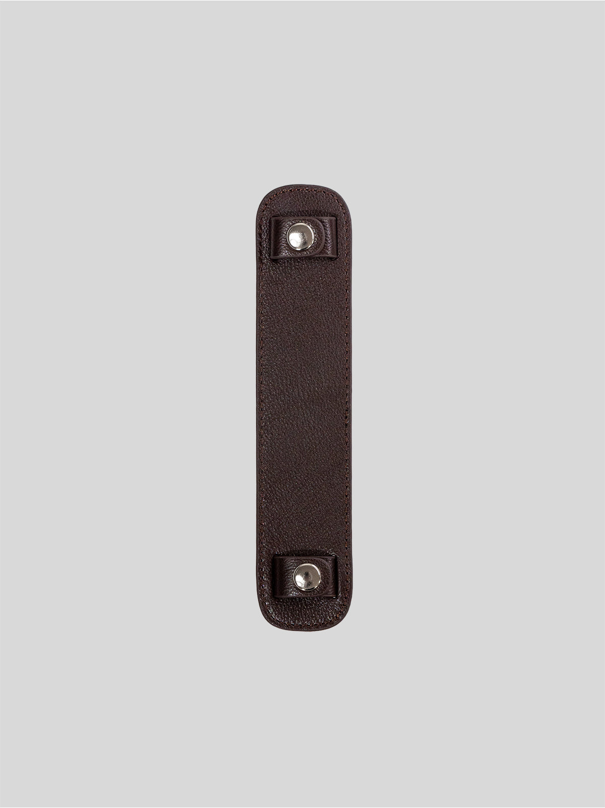 Brown top-grain leather bag strap shoulder pad isolated on grey background